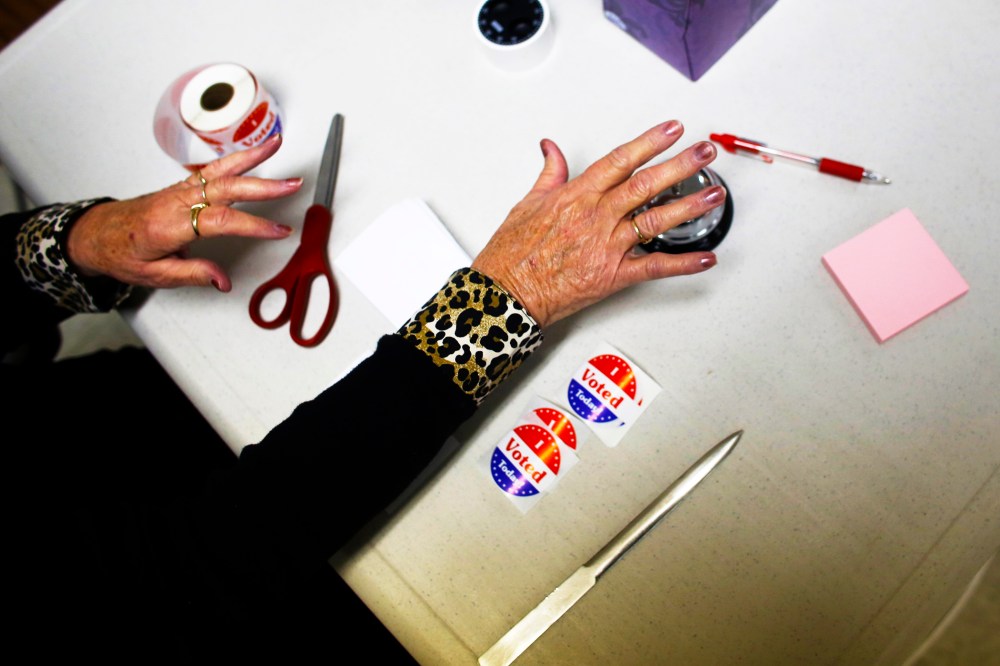 A volunteer poll worker rings a bell to count votes at a polling station on November 6, 2012 in Richmond, Wisconsin.