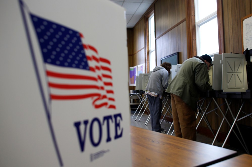 A man and woman cast their vote at a polling station on Nov. 6, 2012 in Sugar Creek, Wis.