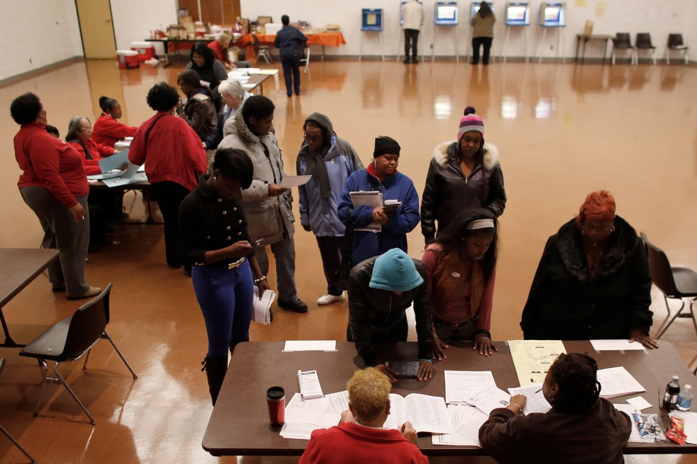 Voters wait in line to register before they can cast their ballots in the U.S. presidential election on Nov. 6, 2012 in Milwaukee, Wisc.