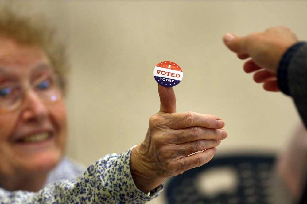 At the Beech Street Center in Belmont, poll worker Rosemary Good handed out "I voted" stickers on Election Day, Nov. 6, 2012.