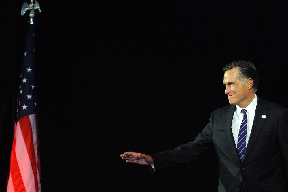 Then, Republican presidential candidate Mitt Romney arrives on stage on Nov. 7, 2012 in Boston, Mass. (Photo by Emmanuel Dunand/AFP/Getty)