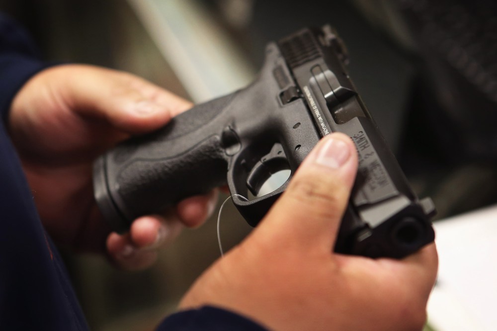 A customer shops for a pistol at a sporting goods store on Dec. 17, 2012 in Tinley Park, Ill.