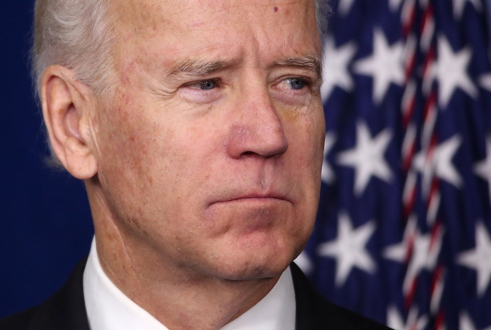 Vice President Biden listens as President Obama speaks during an announcement on gun reform in the Brady Press Briefing Room of the White House December 19, 2012 in Washington, DC.  (Photo by Win McNamee/Getty Images)