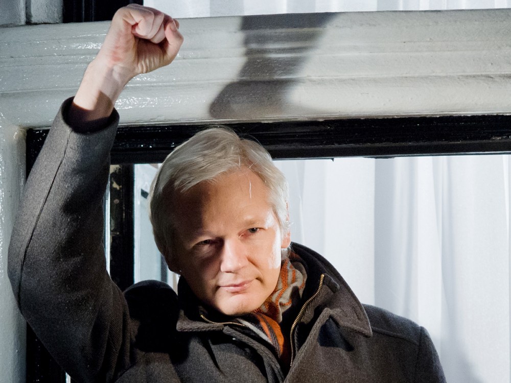 File Photo: Wikileaks founder Julian Assange at the window of the Ecuadorian embassy in Knightsbridge, west London on December 20, 2012. (Photo by Leon Neal/AFP/Getty Images, File)