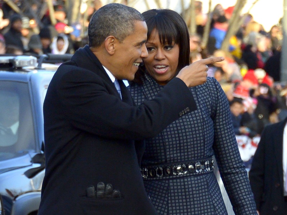 US President Barack Obama and First Lady Michelle Obama walk along Pennsylvania Avenue during the parade following Obama's second inauguration as the 44th US president on January 21, 2013 in Washington, DC. (Photo by Jim Watson/AFP/Getty Images)