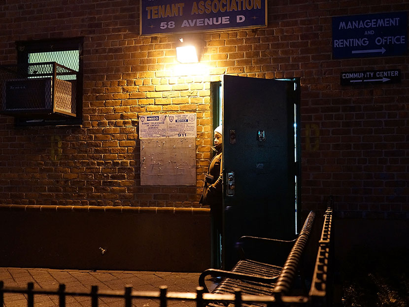 A woman looks out from the door of a housing project on the Lower East Side of Manhattan on January 31, 2013 in New York City.  (Photo by Spencer Platt/Getty Images)