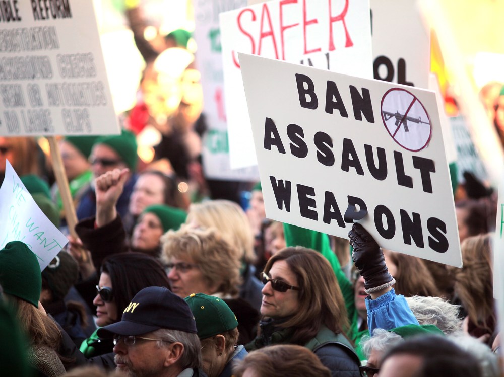 People hold signs during a rally at the Connecticut State Capital to promote gun control legislation in the wake of the December 14, 2012, school shooting in Newtown on February 14, 2013 in Hartford, Connecticut. Referred to as the "March for Change"...