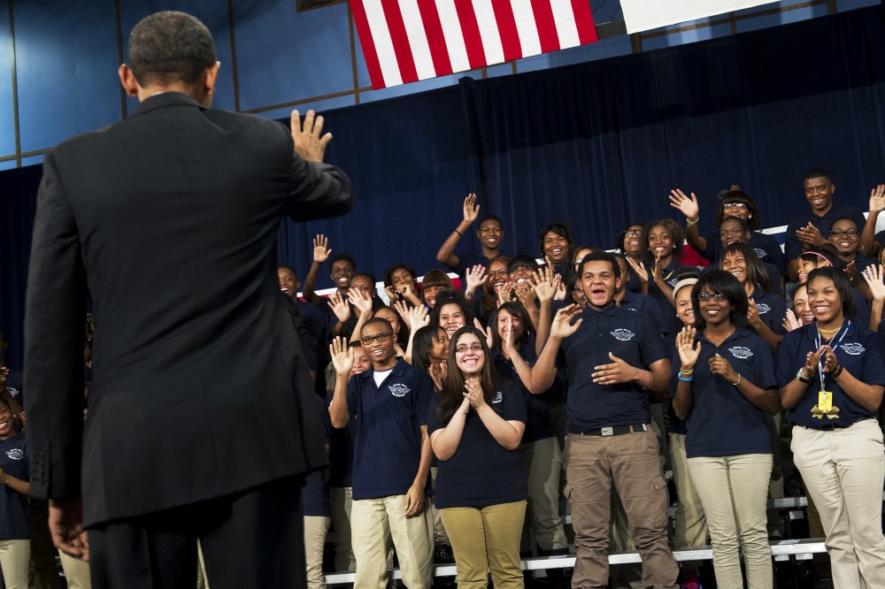 Barack Obama waves to students prior to speaking at Hyde Park Academy in Chicago, Feb. 15, 2013.