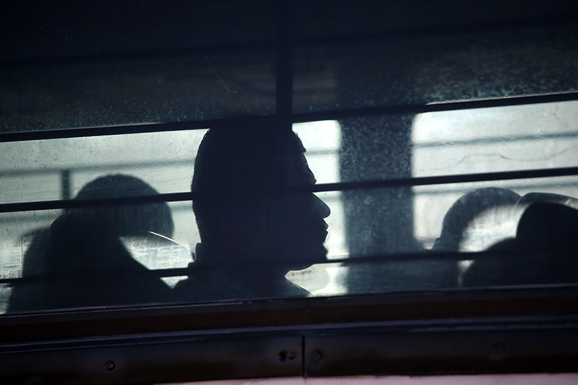 Immigration detainees from Honduras arrive by bus to board a deportation flight to San Pedro Sula, Honduras on February 28, 2013 in Mesa, Arizona. (Photo by John Moore/Getty Images)