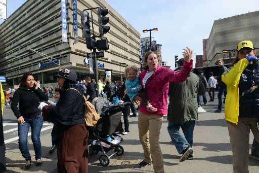 People react to a suspicious package on the corner of Dartmouth and Stuart St after two bombs exploded during the 117th Boston Marathon on April 15, 2013 in Boston, Massachusetts. (Photo by Darren McCollester/Getty Images)