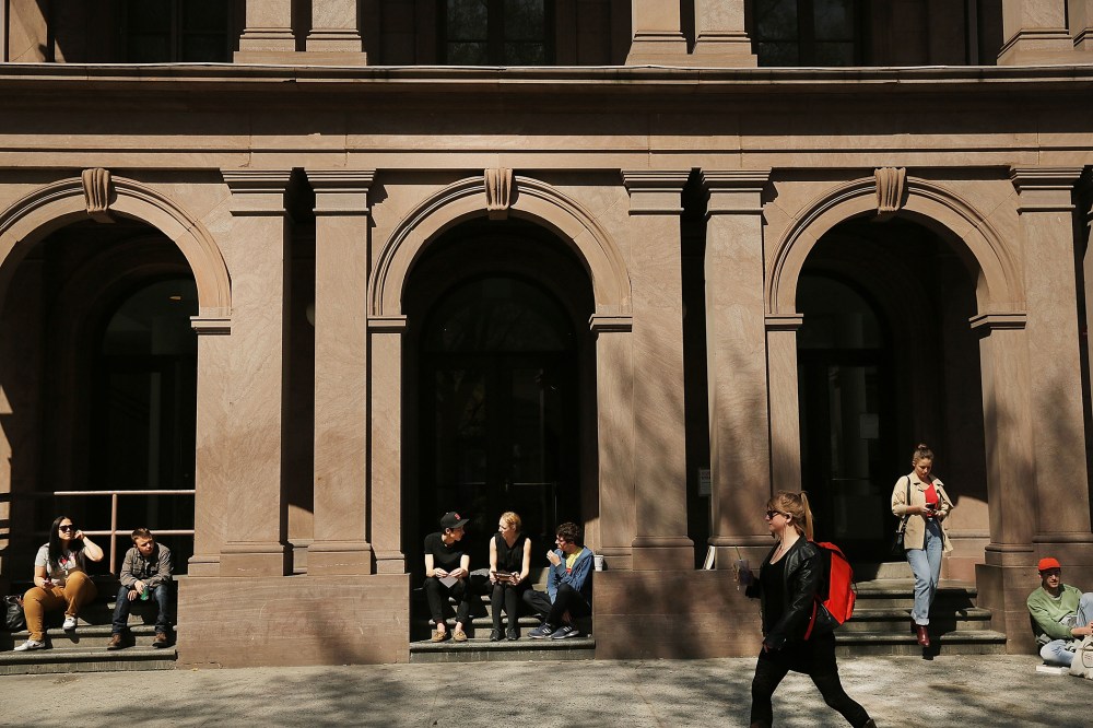 Students sit in front of Cooper Union for the Advancement of Science and Art, on April 24, 2013 in New York City.
