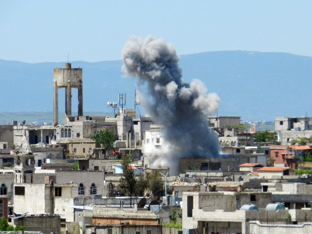 A picture taken on April 26, 2013 shows smoke rising after shelling in Houla in Syria's Homs province. The opposition National Coalition has accused the regime of using chemical weapons in the northern province of Aleppo, in Homs in central Syria, and...