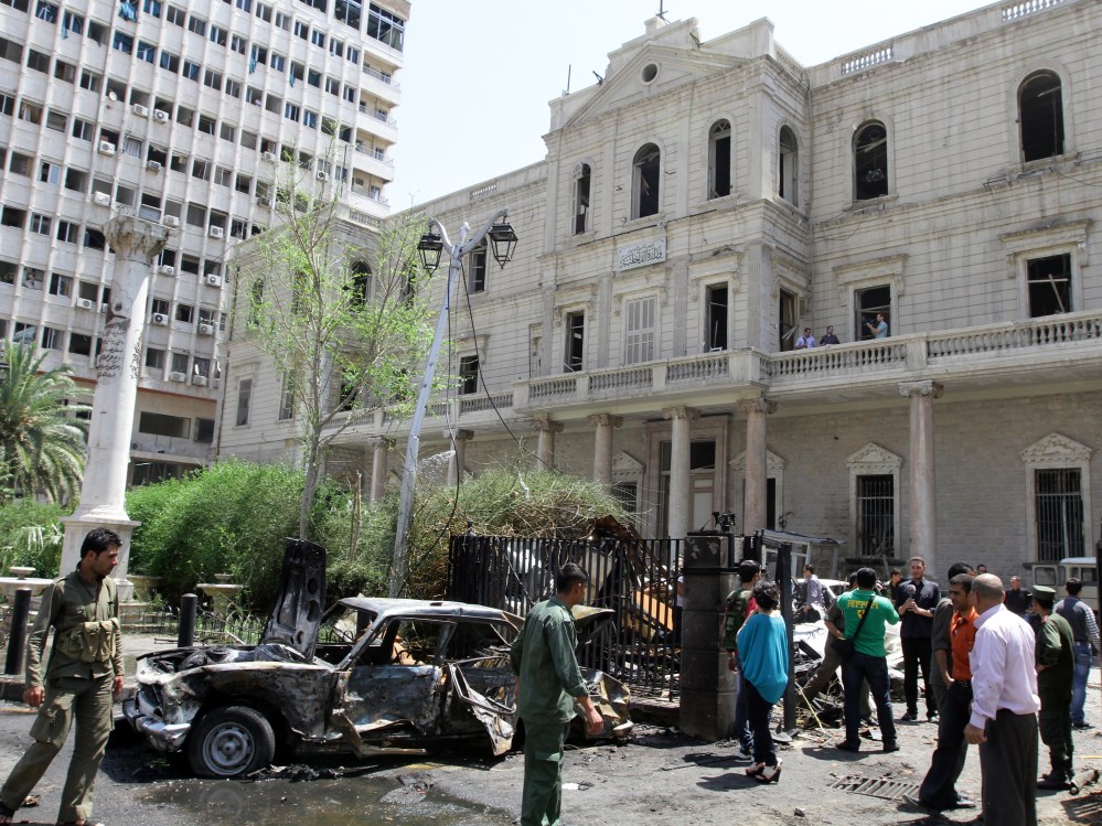 A destroyed car sits outside the Syrian Interior Ministry following a bomb blast in the Marjeh district of Damascus on April 30 , 2013. A blast in the central Damascus district of Marjeh killed at least 14 people, Syrian state television reported, a...