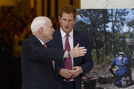 WASHINGTON, DC - MAY 09:  Prince Harry (R) tours a HALO Trust photo exhibit on landmines and unexploded ordinances, with Republican Senator from Arizona John McCain (L),  on Capitol Hill on May 9, 2013 in Washington, DC.(Photo by Michael Reynolds-Pool...