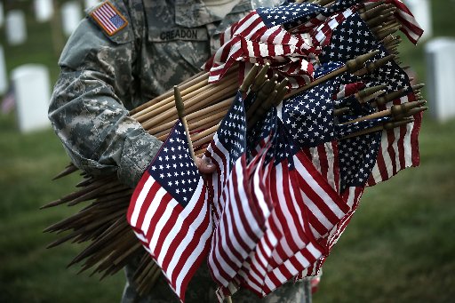 A member of the Fife and Drum Corps of the 3rd U.S. Infantry Regiment, "The Old Guard," participate in a "Flags-In" ceremony May 23, 2013 at Arlington National Cemetery in Arlington, Virginia. A small American flag was placed one foot in front of more...