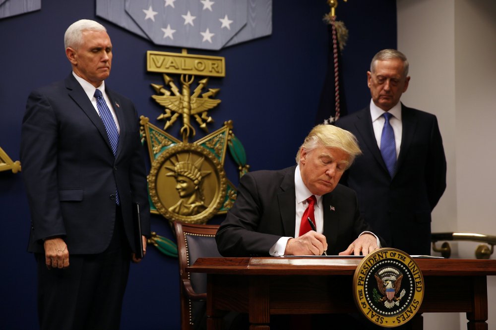 Image: U.S. President Donald Trump signs a revised executive order for a U.S. travel ban on Monday, leaving Iraq off the list of targeted countries at the Pentagon in Washington, U.S.