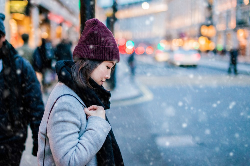 Image: Young Asian walking on the street under snow