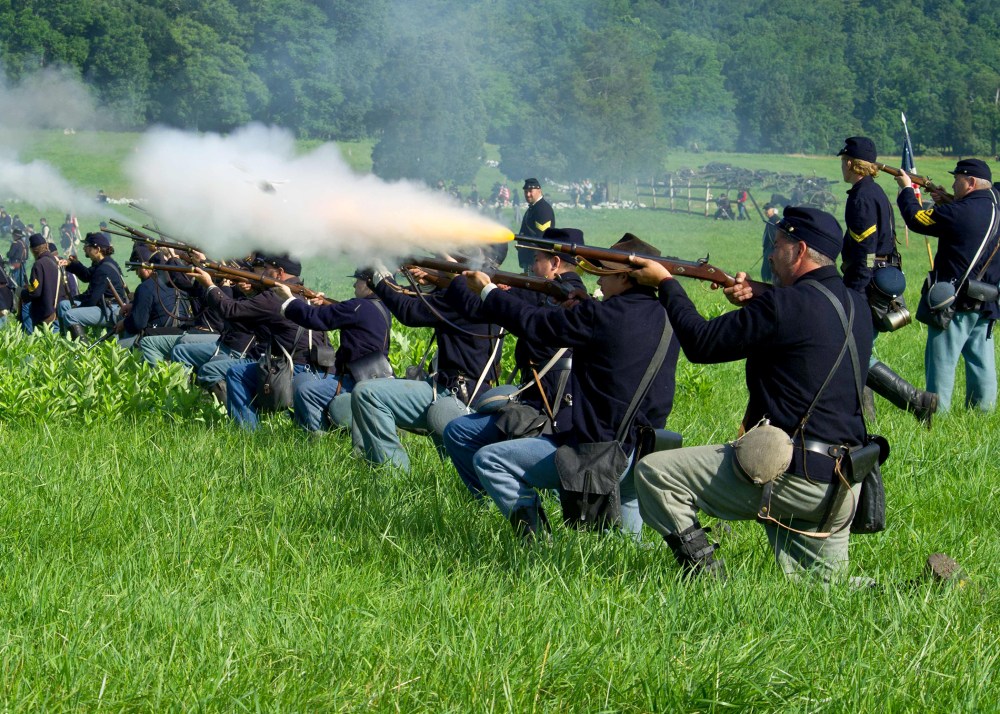Union soldiers fire a volley at Confederate troops during re-enactment of the Battle of Gettysburg on June 28, 2013.
