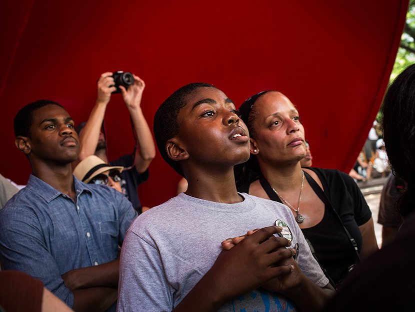 A boy cranes his head to hear a speaker while attending a rally in support of Trayvon Martin, organized by the Reverand Al Sharpton, in response to the non-guilty verdict for George Zimmerman on July 20, 2013 in New York City.  (Photo by Andrew Burton...