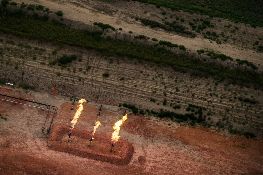 A gas flare is seen in an aerial view in the early morning hours of July 30, 2013 near Watford City, North Dakota.