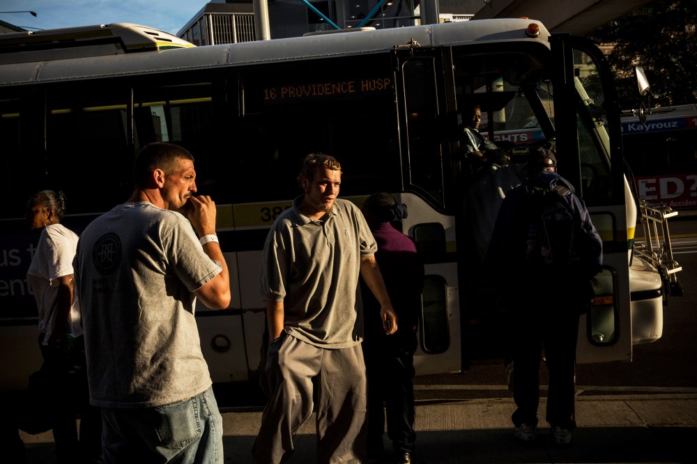 People board a public transit bus in Detroit, Michigan, Sept. 6, 2013.