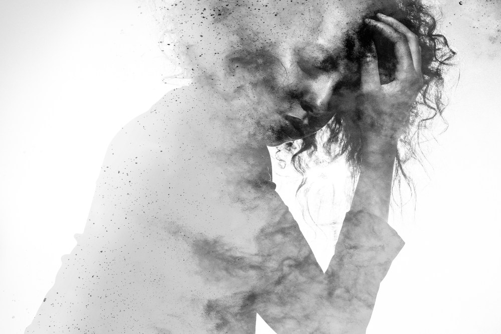 Image: Unhappy woman's form double exposed with paint splatter effect