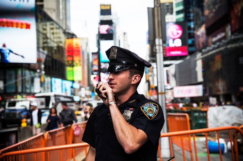 A New York Police Department officer speaks on his radio in Times Square, Sept. 22, 2013.