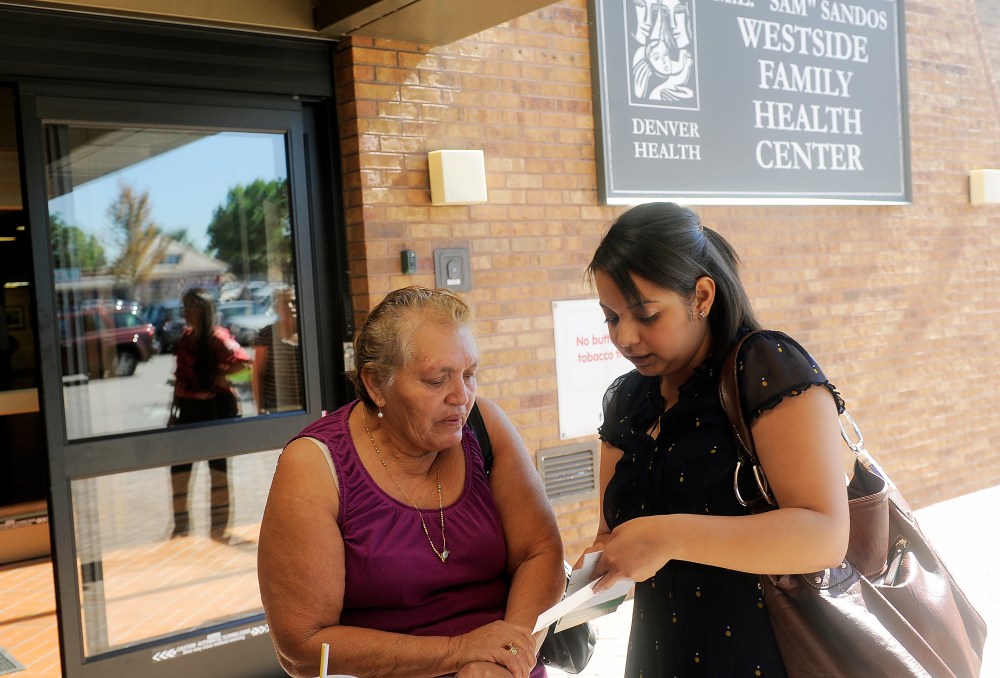 Lida Galindo talks with Mirian Morales,about the Affordable Care Act outside of the Denver Health Westside Family Health Center on October 01, 2013 in Colorado.