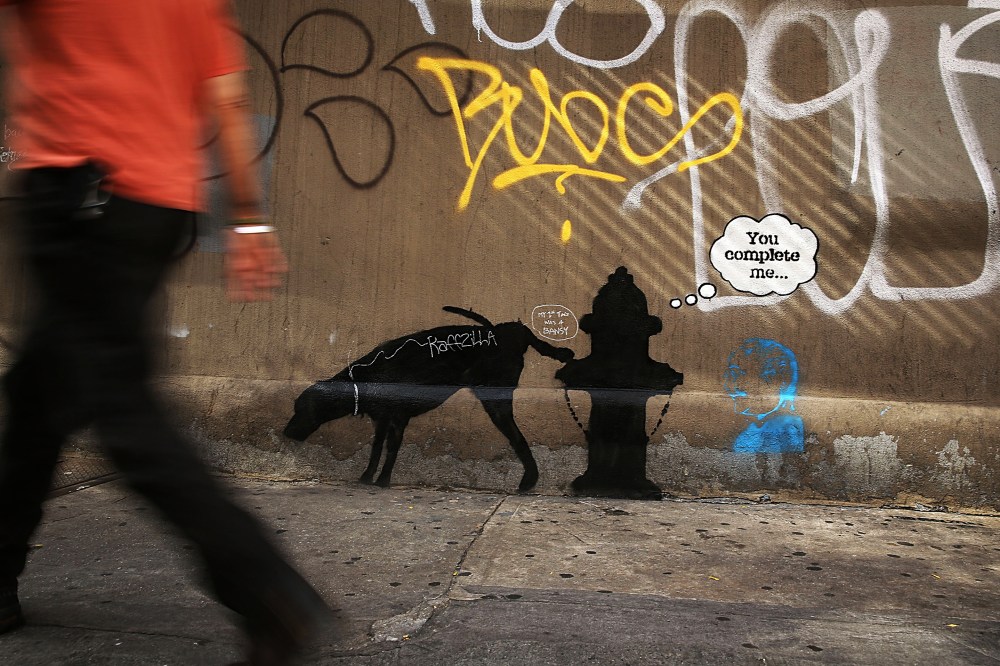 A new Bansky work on a side of a wall is viewed on Oct. 3, 2013 in New York City.