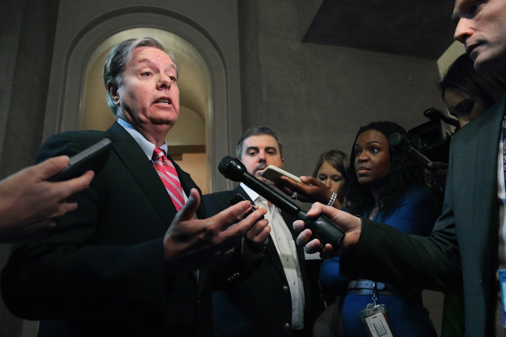 Sen. Lindsey Graham (R-SC) talks to reporters after leaving a Senate Republican caucus meeting at the U.S. Capitol on Oct. 11, 2013 in Washington, DC.