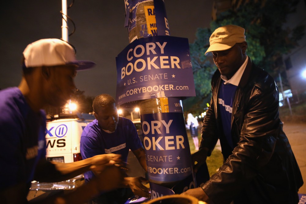 Campaign workers for Newark Mayor Cory Booker put up signs outside a polling station for a special U.S. Senate election on October 16, 2013 in Newark, New Jersey.