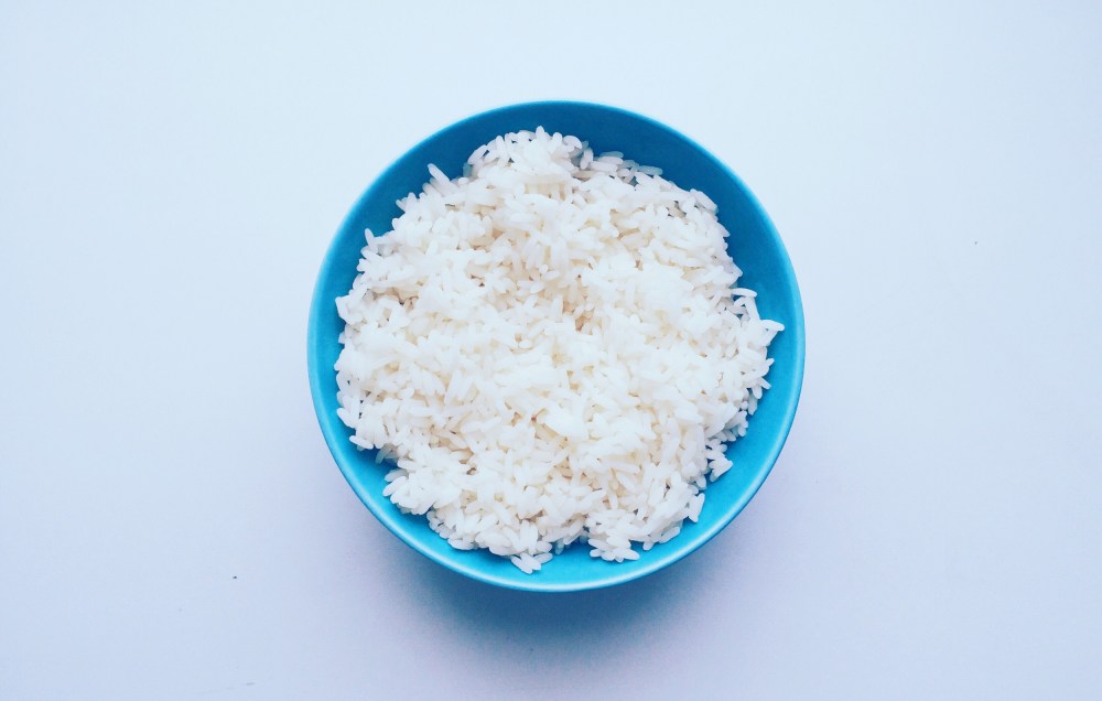 Directly Above Shot Of Rice In Bowl Over White Background
