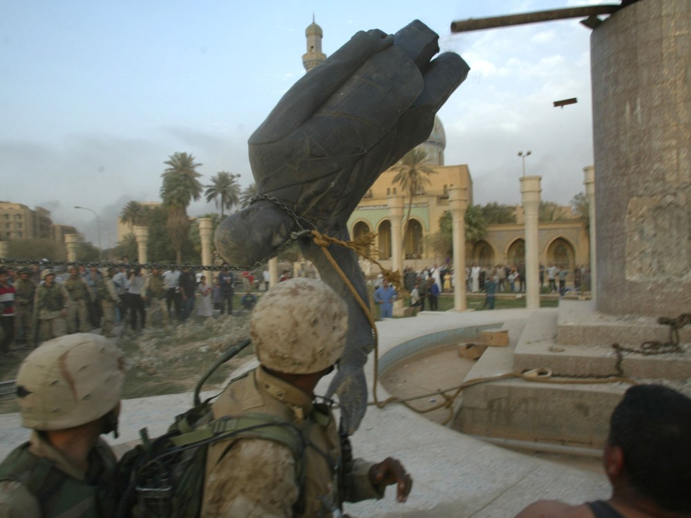 File Photo: U.S. Marines from the Marine 1st Division take down a Saddam Hussein statue April 9, 2003 in Baghdad, Iraq. (Photo by Robert Nickelsberg/Getty Images, File)