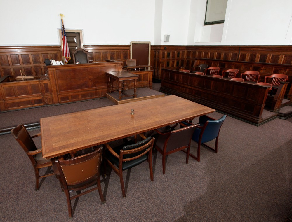 A view of the table, where the plaintiff and defendant will sit at and look towards the judge's chair (rear L), the witness stand (rear R), stenographer's desk (rear C) and jury box (R) in court room 422 of the New York Supreme Court at 60 Centre Street F