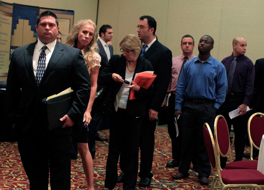 People wait in line to meet with recruiters during a job fair in Melville, New York July 19, 2012.