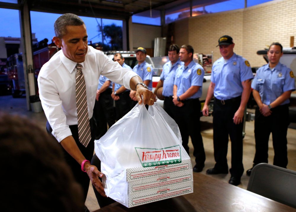 U.S. President Barack Obama delivers doughnuts to fire fighters at a fire house in Tampa, Florida October 25, 2012. Note to Rand Paul: He's dropping off, not confiscating.