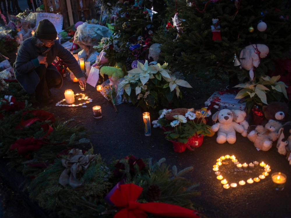 A woman lights candles at a memorial for victims of the Sandy Hook Elementary shooting near the school in Sandy Hook Village in Newtown, Connecticut.  (Photo by Adrees Latif/Reuters)