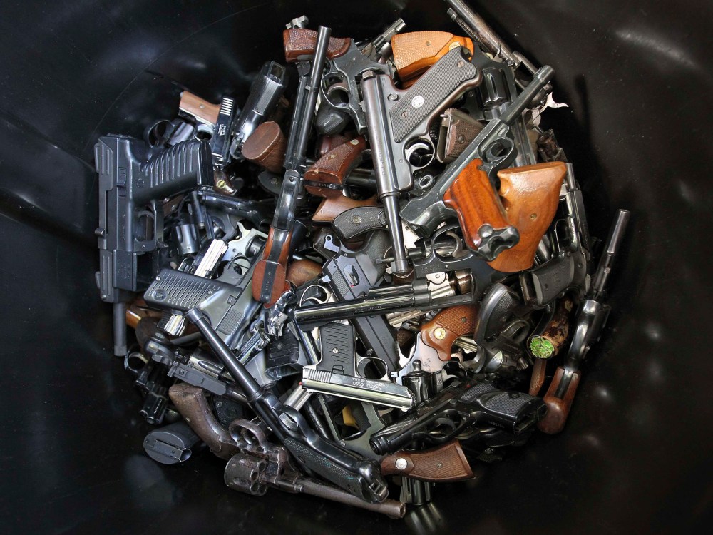 Hand guns that were turned in by their owners are seen in a trash bin at a gun buyback held by the Los Angeles Police Department following the mass shooting at Sandy Hook Elementary School in Connecticut, in Los Angeles, California, December 26, 2012. ...