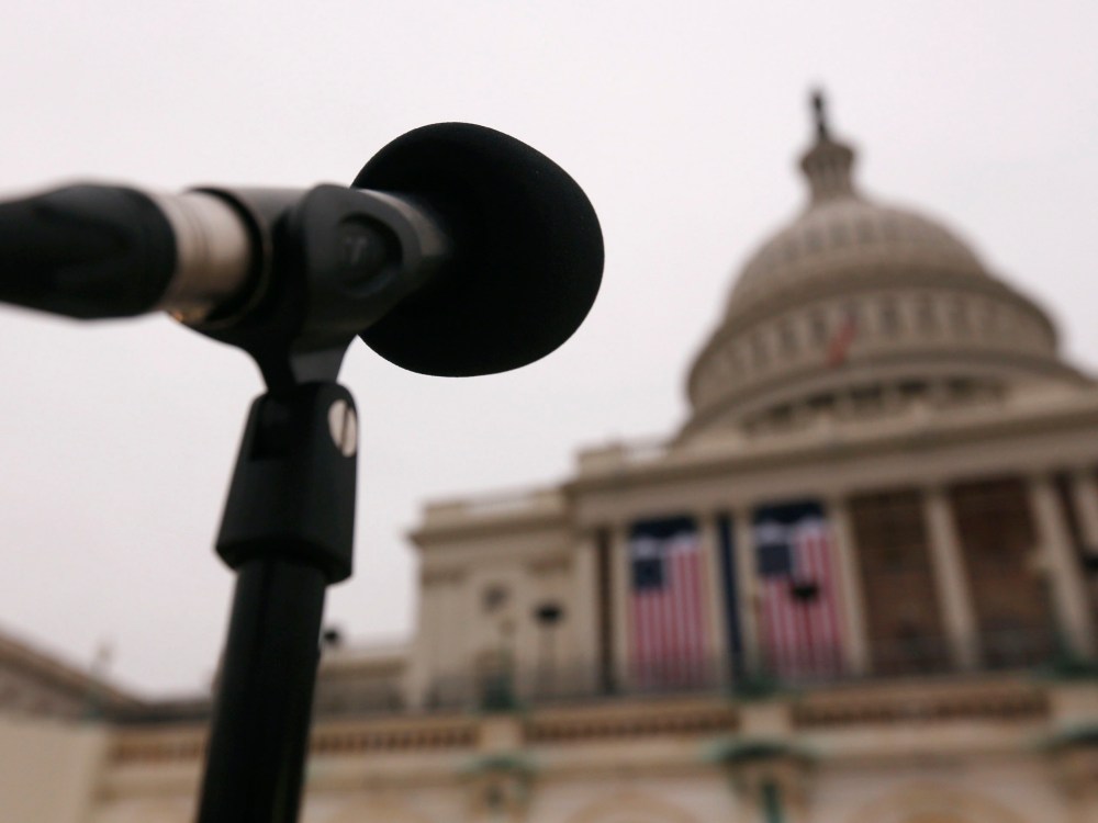 Image: The dome of the U.S. Capitol building is seen past a microphone during a rehearsal for the inaugural ceremonies in Washington