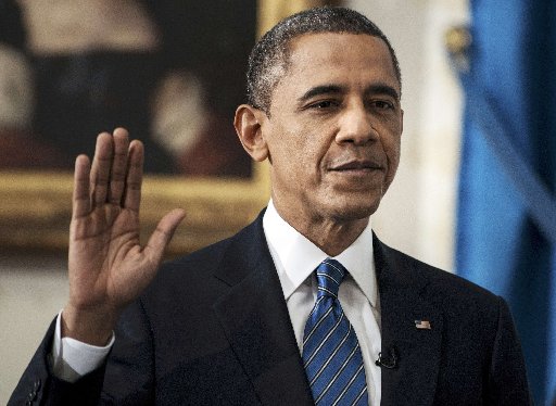 U.S. President Barack Obama is sworn in for a second term as President of the United States in the Blue Room of the White House in Washington, DC January 20, 2013. (Photo by Brendan Smialowski/Reuters/Pool)