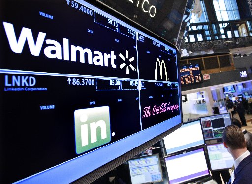 A board shows stock prices for Wal-Mart at the booth they are traded on the floor of the New York Stock Exchange, in this March 6, 2012 file photo. (REUTERS/Brendan McDermid/Files)