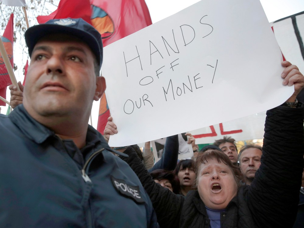 Protesters shout slogans during an anti-bailout rally outside the parliament in Nicosia March 19, 2013. Cyprus's government proposed to spare small savers from a divisive levy on bank deposits but said it expected parliament to reject the measure,...