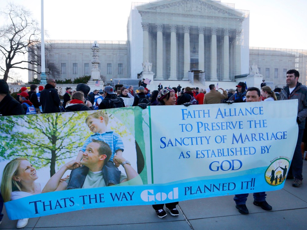 Protesters in favor of Proposition 8 hold a banner outside of the U.S. Supreme Court in Washington, March 26, 2013. (Photo by Jonathan Ernst/Reuters)