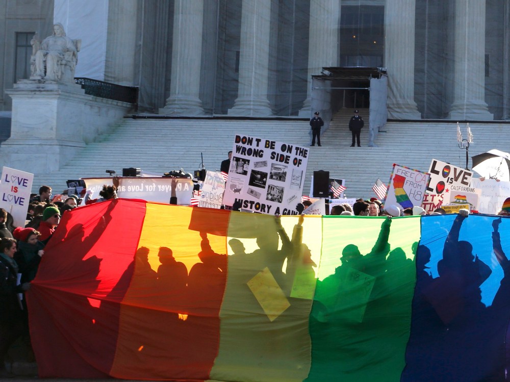 Anti-Proposition 8 protesters are shadowed by a rainbow banner in front of the U.S. Supreme Court in Washington, March 26, 2013. (Photo by Jonathan Ernst/Reuters)