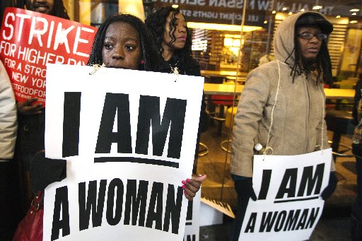 Demonstrators protesting low wages and the lack of union representation in the fast food industry chant and hold signs outside of a McDonald's restaurant near Times Square in New York, April 4, 2013.  (REUTERS/Lucas Jackson)