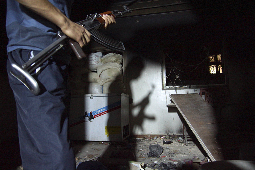 The shadow of a Free Syrian Army fighter is cast on a wall in Deir al-Zor July 22, 2013. (Photo by Khalil Ashawi/Reuters)