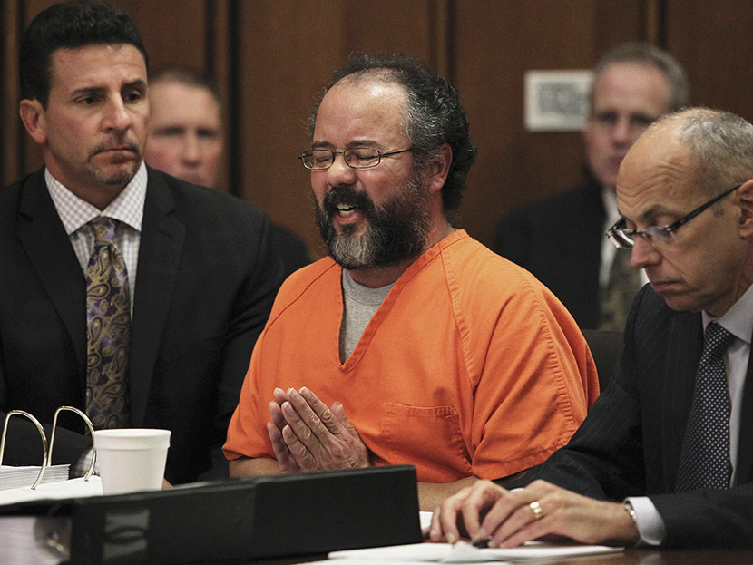Ariel Castro (C), 53, breaks down while talking about the child that he fathered with Amada Berry as he addresses the court while seated between attorneys Craig Weintraub (L) and Jaye Schlachet in the courtroom in Cleveland, Ohio August 1, 2013.  ...