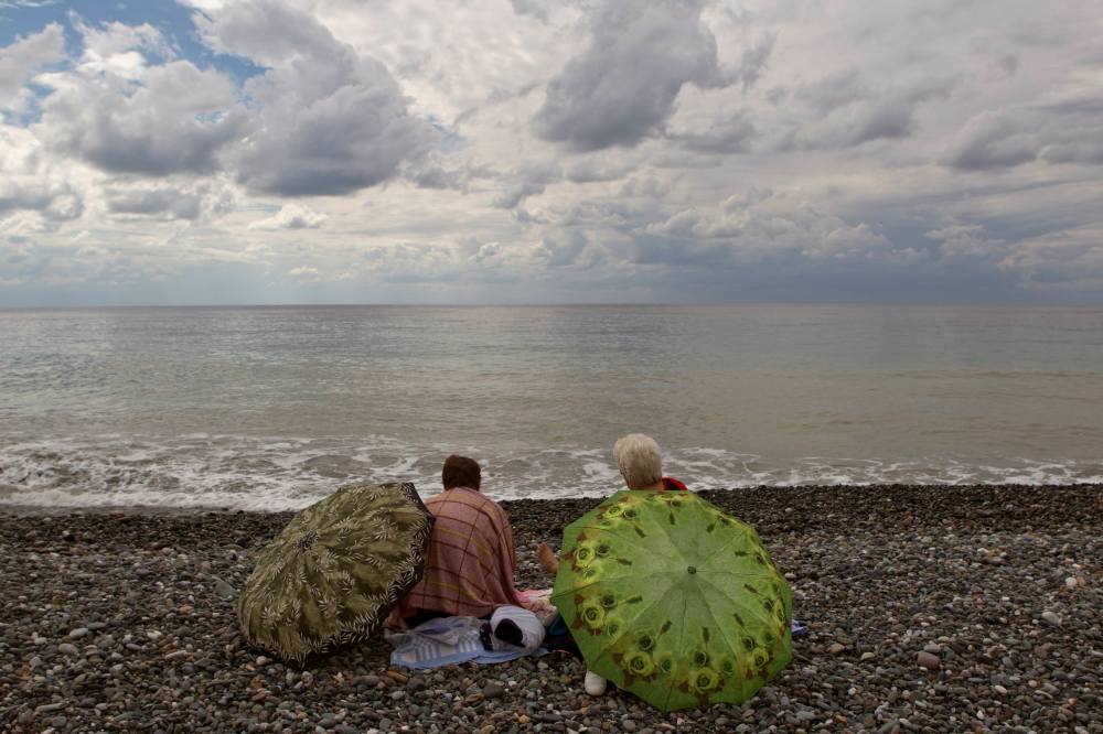 Women enjoy the sun on the beach, September 22, 2013.