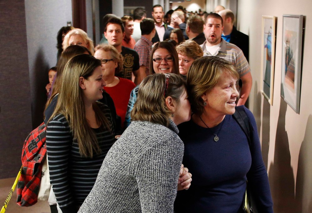 Same-sex couples, accompanied by their friends and family members, line up to get marriage licenses at the Salt Lake County Government Building in Salt Lake City, Utah, December 23, 2013.