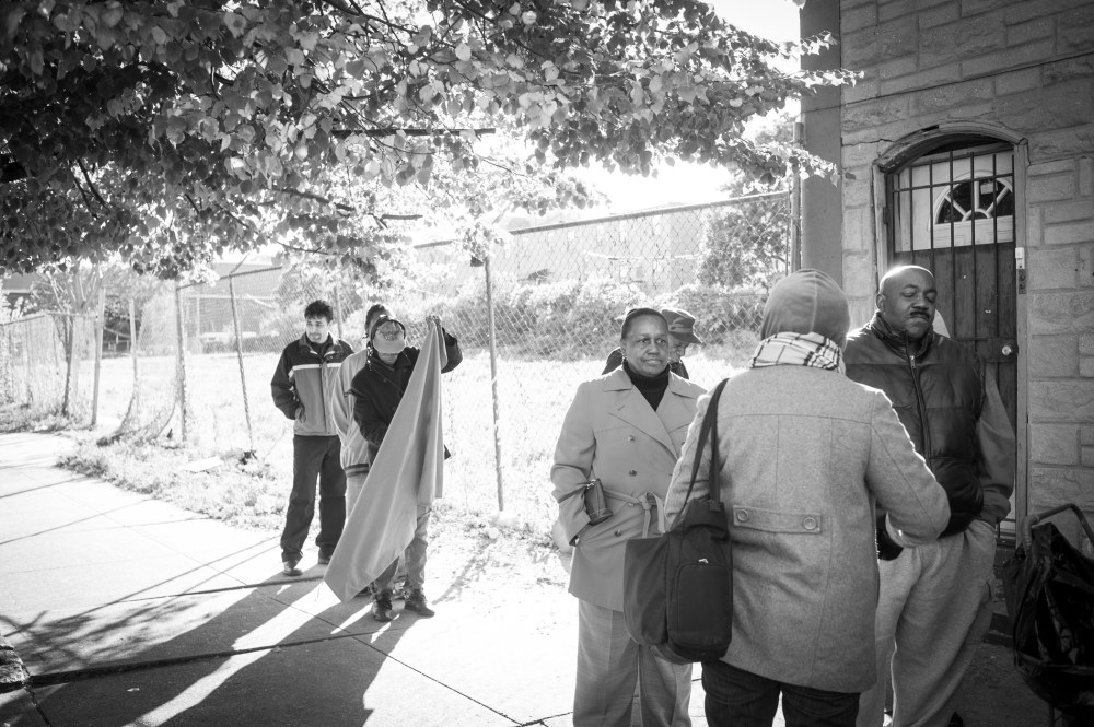 People wait in line along Fulton Street for the opening of the Bed-Stuy Campaign Against Hunger.